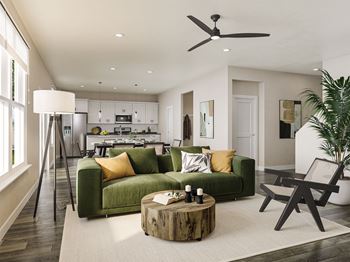 a living room with a green couch and a wooden coffee table